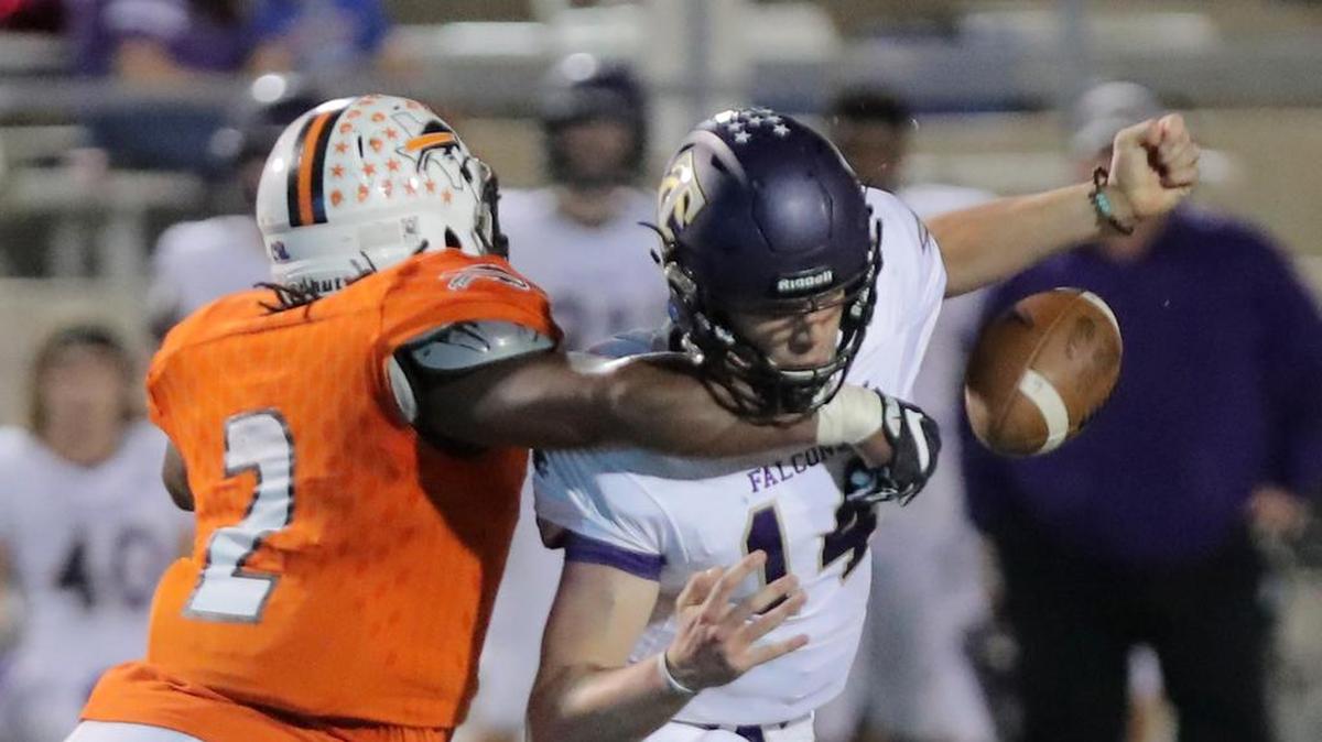 Haltom linebacker Zacc Smith strips the ball from Timber Creek quarterback Adrian Ranete. Each team is seeking the same playoff spot.