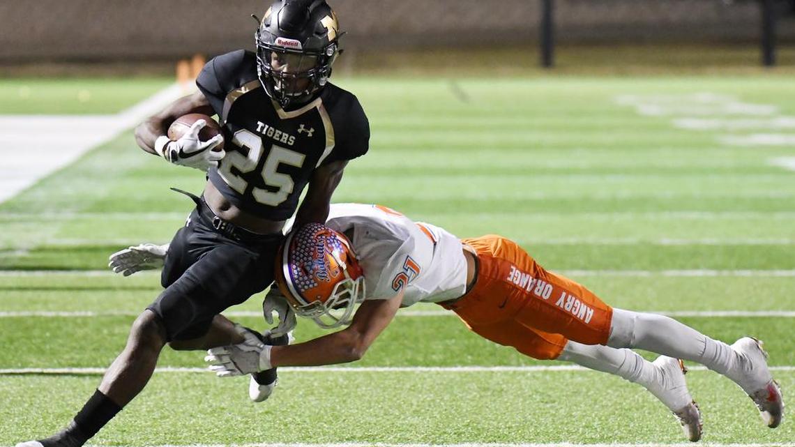 Mansfield’s Jaqulis Coleman, left, is tripped up short of the goal line by San Angelo Central’s Jakobe Green but enough for a first down in the fourth quarter.