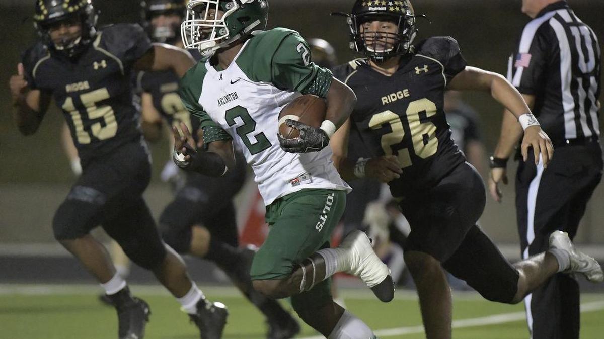 Arlington Colts running back Kenland McCray (2) returns a second quarter punt as Fossil Ridge Panthers Yahya Salim (15) and Marco Olivas (26) give chase in Friday night’s game in Keller.