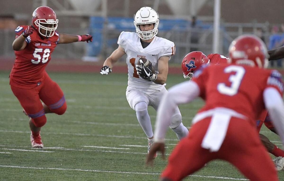 Bowie Volunteers receiver Ty DeArman (10) scrambles for yards as Sam Houston Texans Steven Delorbe (58) closes in during the first quarter as Bowie plays Sam Houston at Wilemon Field in Arlington, TX, Thursday, Oct. 5, 2017.