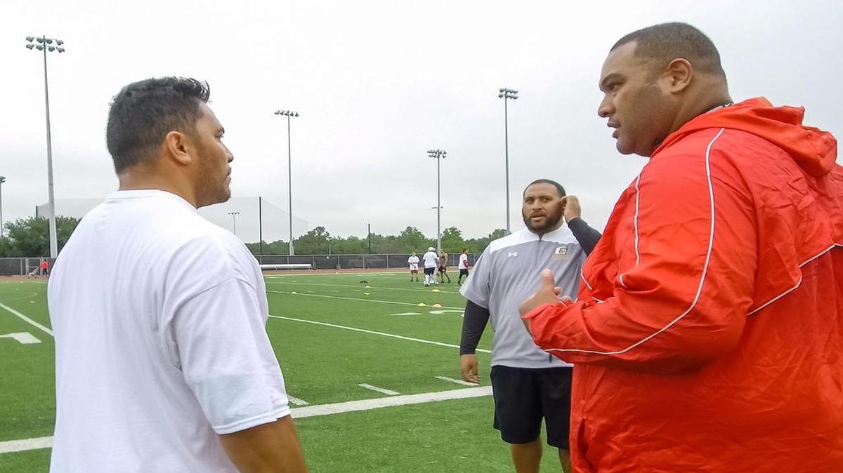 Moses Vakalahi (right) speaks with Speltar Tonga at the annual summer Ikuna Sports Camp.
