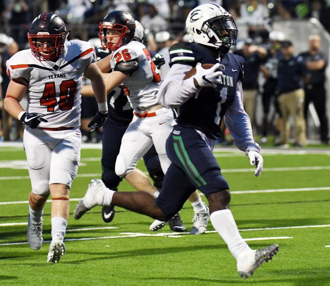 Eaton's Titus Swen, right, runs into the end zone for a touchdown against Northwest.