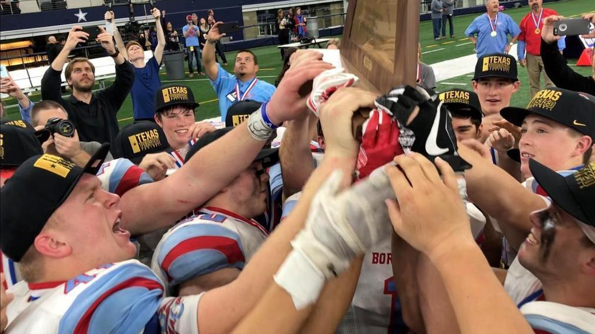 Gail Borden County players celebrate with the Class A Division I championship trophy.