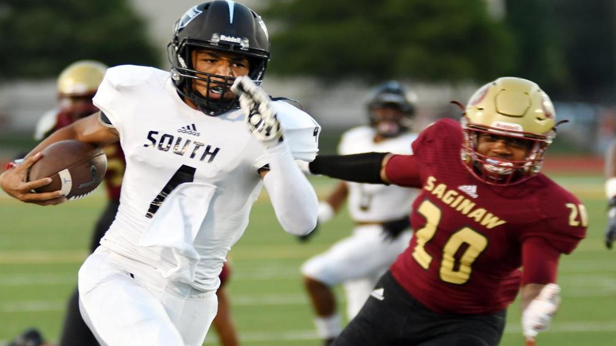 South Hills quarterback Tracin Wallace, left, breaks away from Saginaw's Patrick Hayes for a 61 yard touchdown run to take a 14-0 lead during a game on Sept. 2.