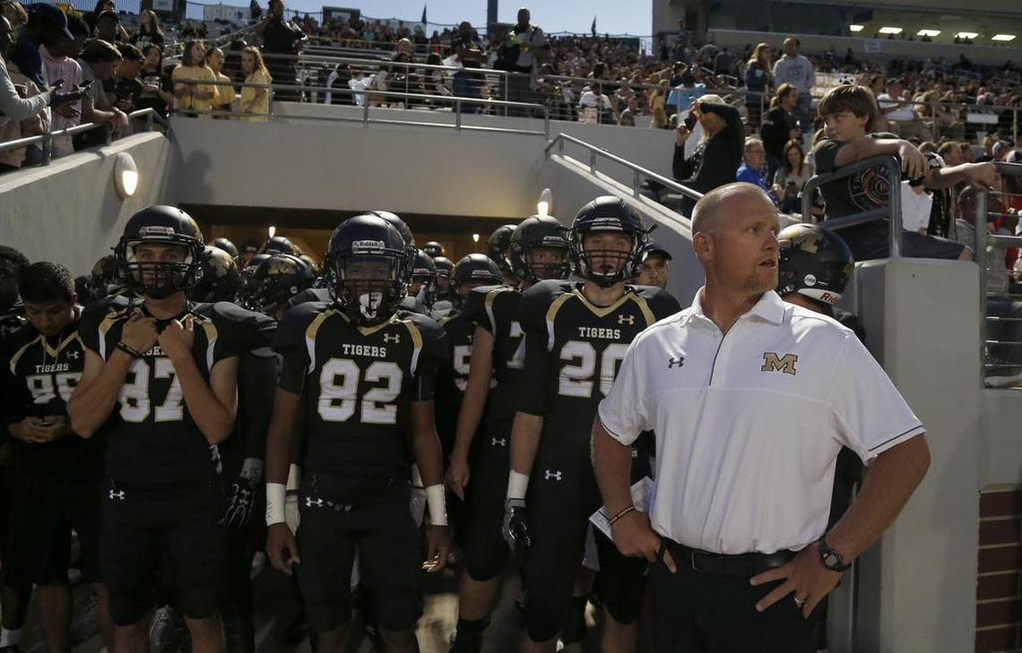 Mansfield Tigers head coach Daniel Maberry, left, awaits the signal to send his team onto the field at Newsom Stadium in Mansfield. The Tigers beat Arlington, 43-14.