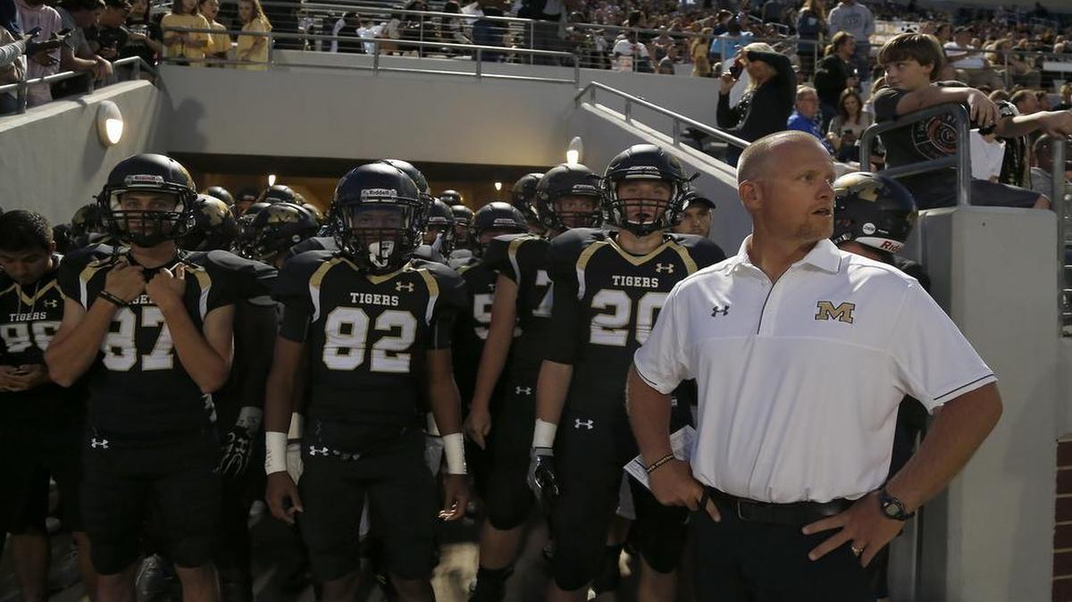 Mansfield Tigers head coach Daniel Maberry, left, awaits the signal to send his team onto the field at Newsom Stadium in Mansfield. The Tigers beat Arlington, 43-14.