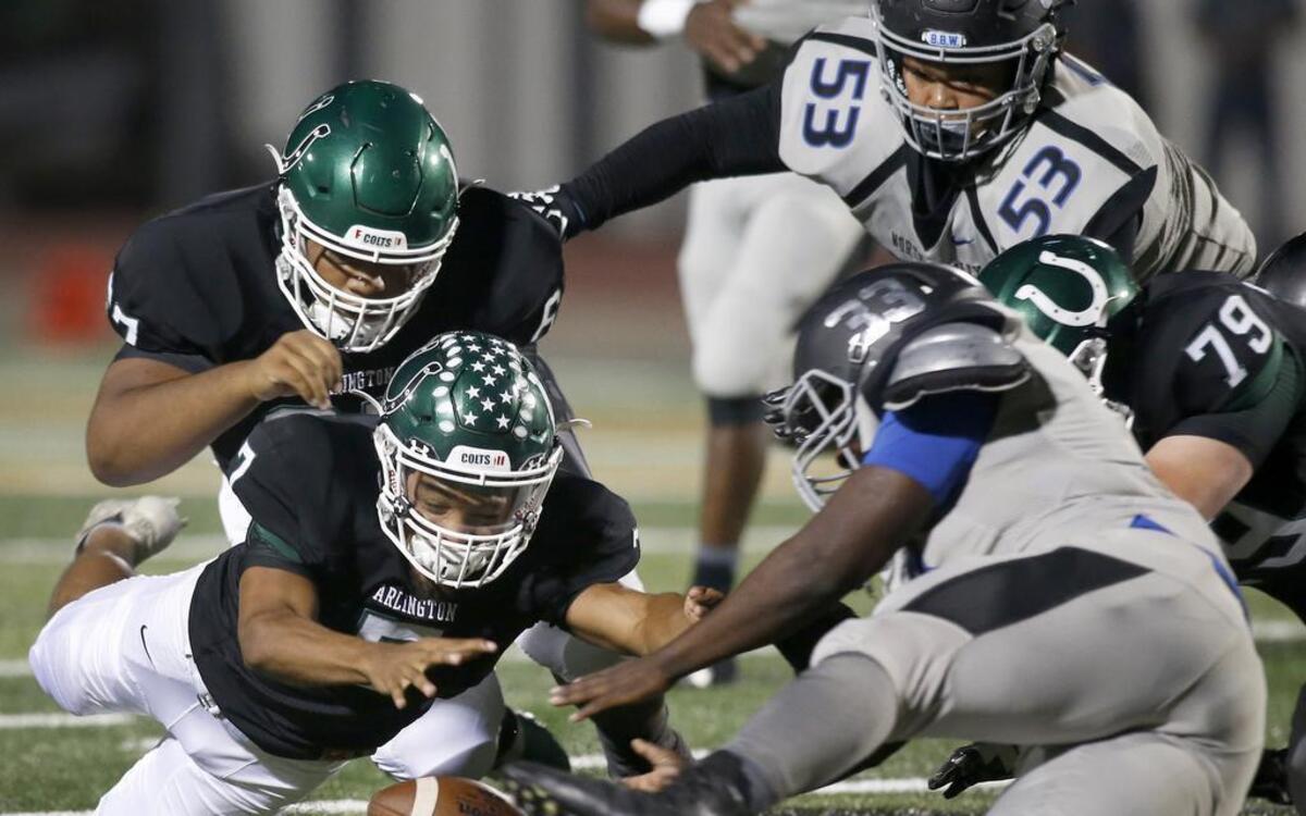 Arlington Colts quarterback D'montae Davis (7) scrambles for a fumble against North Crowley Panthers Mark Shelton (33) in the first half of a high school football game at UTA Maverick Stadium in Arlington, Texas on Friday, Sept. 29, 2017.