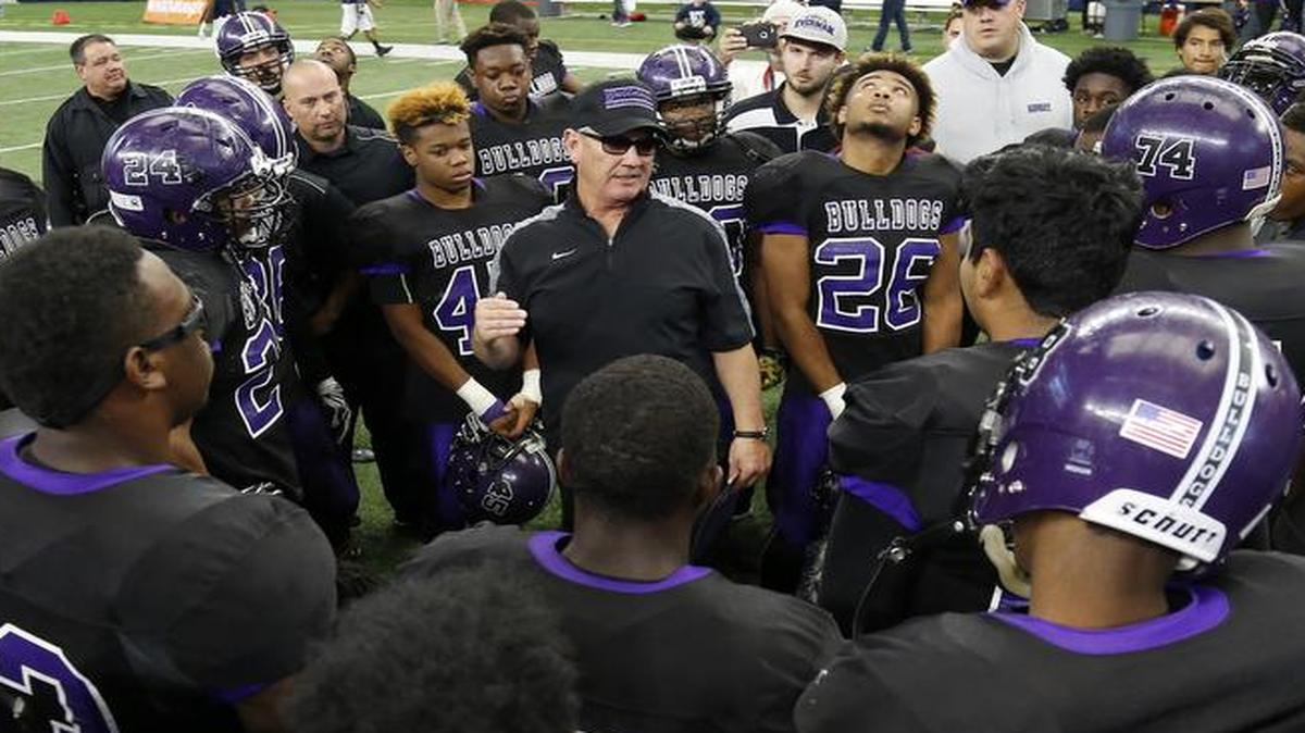 Everman Bulldogs head coach Dale Keeling talks with his players against the Lake Dallas Falcons in high school football playoff action at AT&T Stadium in Arlington, Texas Saturday, Dec. 5 2015.