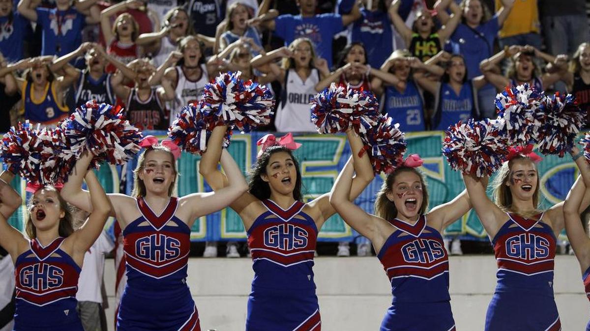 Grapevine Mustangs cheerleaders and fans cheer their team against the Richland Rebels in the first half of a high school football game at Mustang-Panther Stadium in Grapevine, Texas on Friday, Oct. 20, 2017.