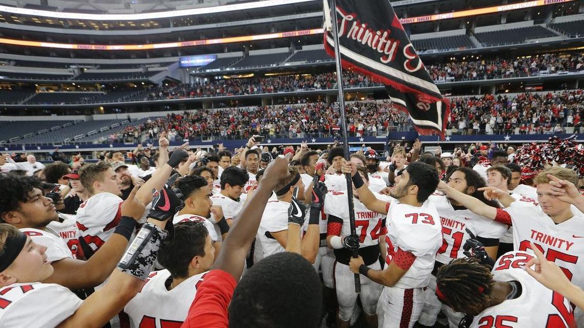 Euless Trinity players celebrate the Trojans’ 28-27 playoff victory Duncanville at AT&T Stadium in Arlington, Saturday, Nov. 25, 2017.