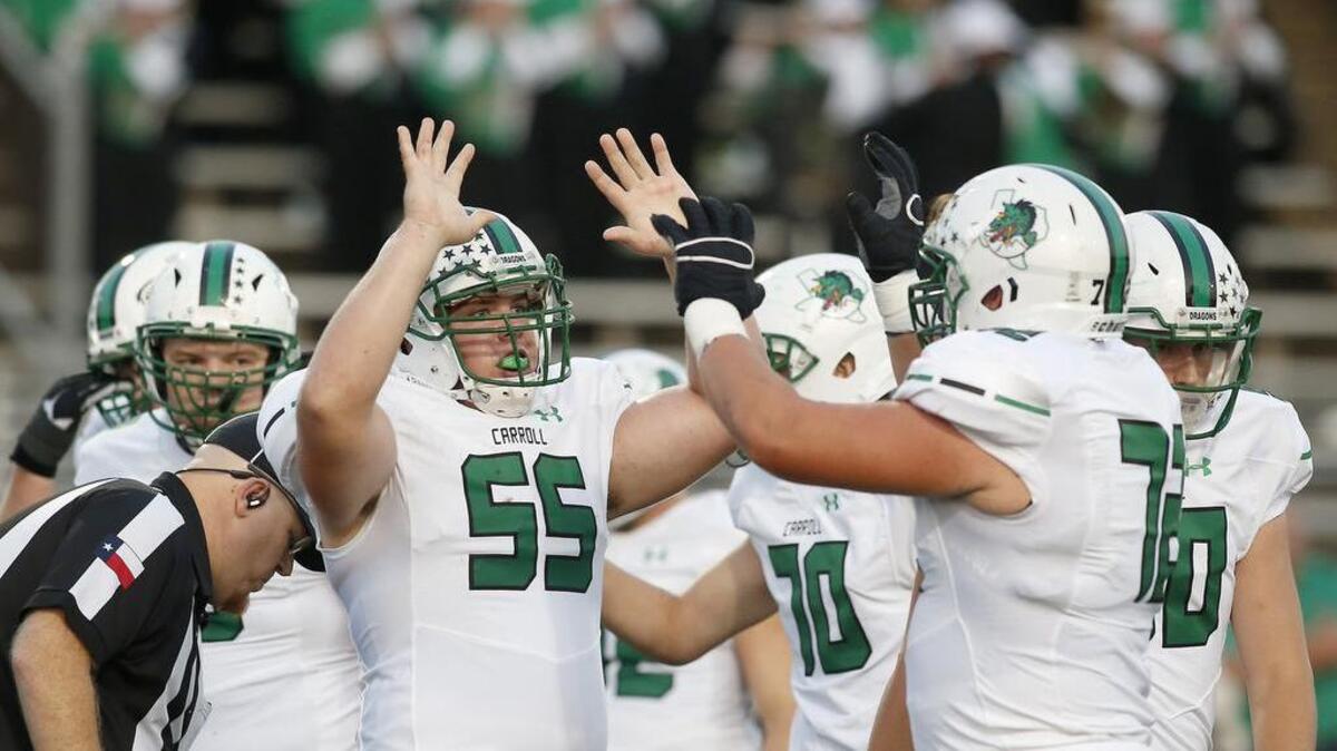 Southlake Carroll guard Matthew Leehan (55) and offensive lineman Jackson Kimble (72) celebrate a touchdown in a September game.