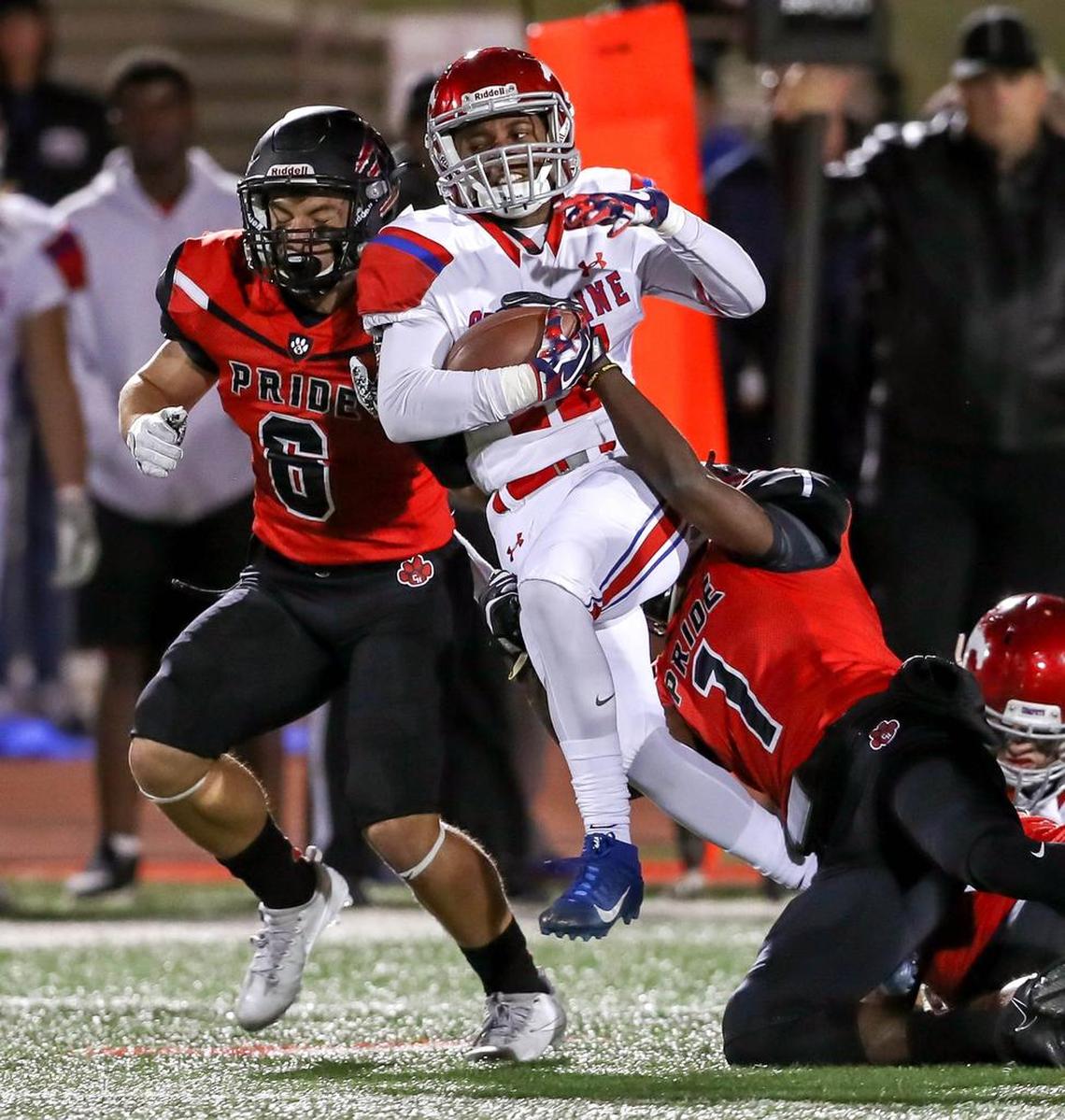 Grapevine running back RoShawn Prear fights for yardage against Colleyville Heritage in Grapevine.