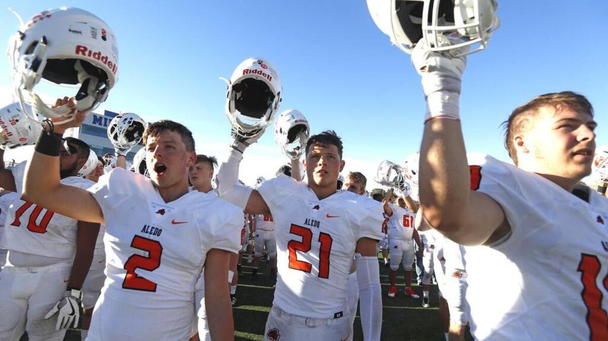 Aledo players Tripp Jones (2) and Zach Reinert (21) celebrate their 5A Division II area round playoff game against Grapevine at Midlothian Multi-Purpose Stadium Friday November 23, 2017.