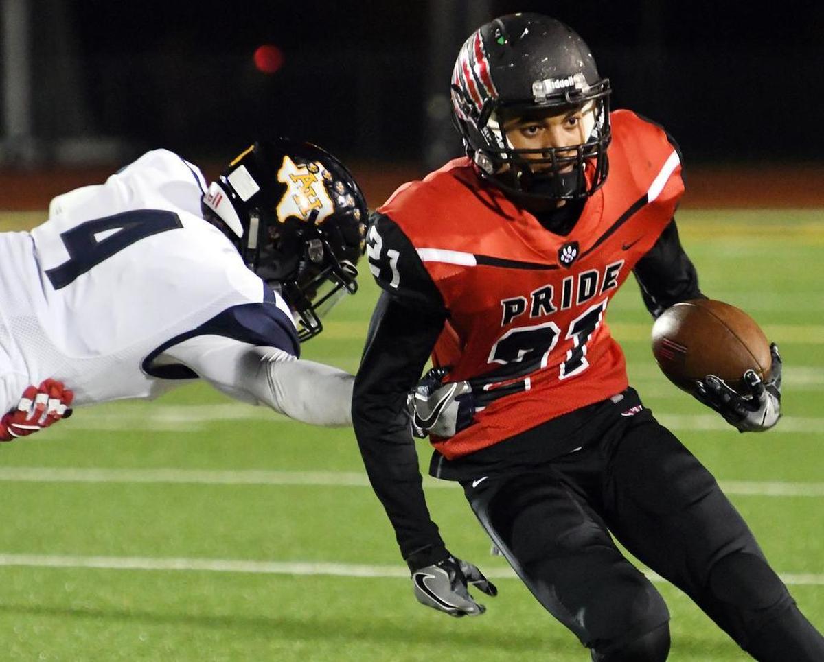 Colleyville Heritage receiver Kamron Brown (21) attempts to evade Arlington Heights defender Darius Williams in a 2016 game. Brown is committed to Texas A&M.