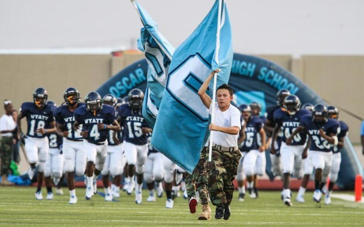 In a 2013 game against Dunbar, Wyatt players take the field at Clark Stadium.