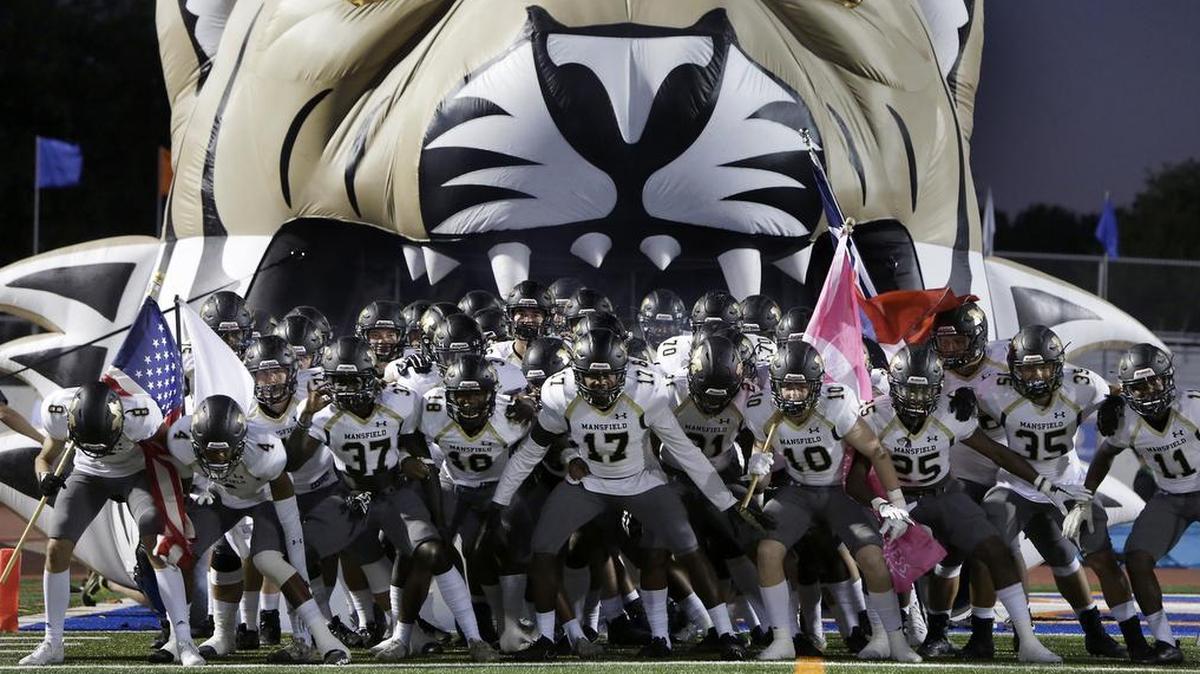 The Mansfield Tigers prepare to take the field for the first half of a high school football game against the Arlington Colts at UTA Maverick Stadium in Arlington, Texas, Oct. 6, 2017.