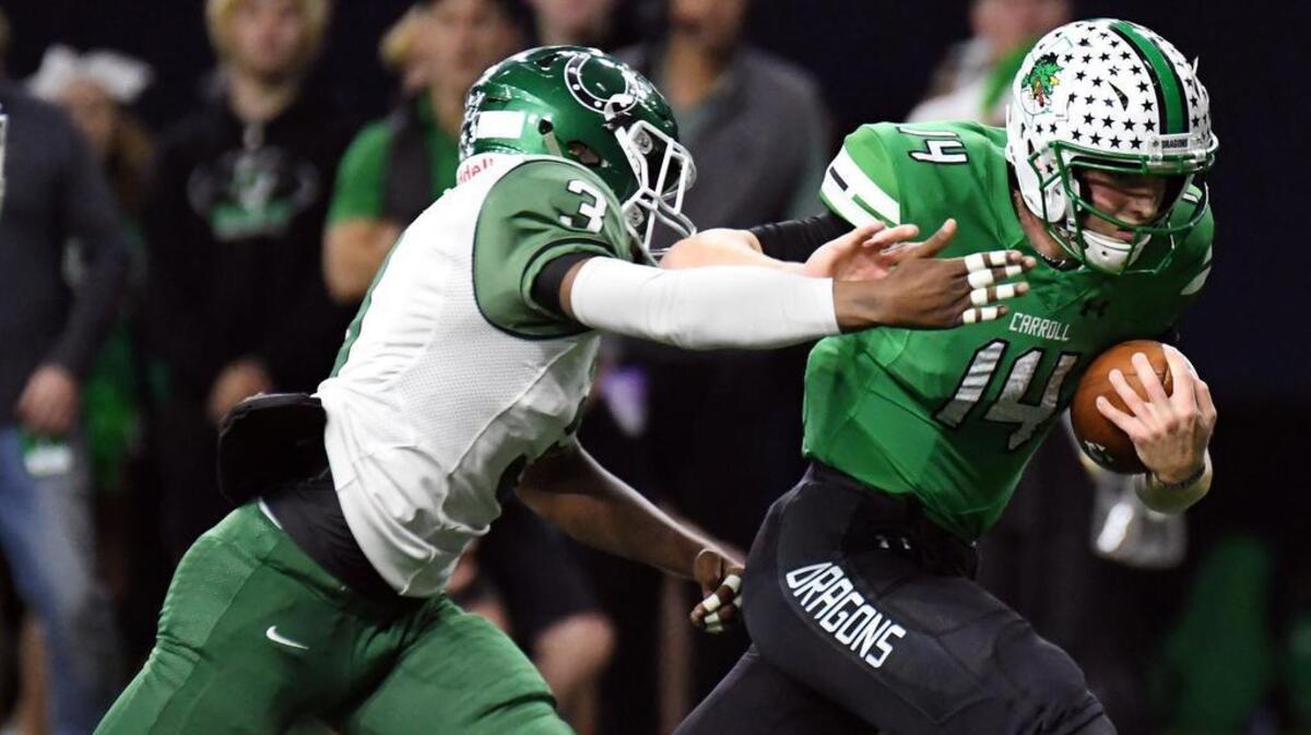 Arlington’s Kyron White, left, pursues Carroll quarterback Will Bowers in the first quarter.