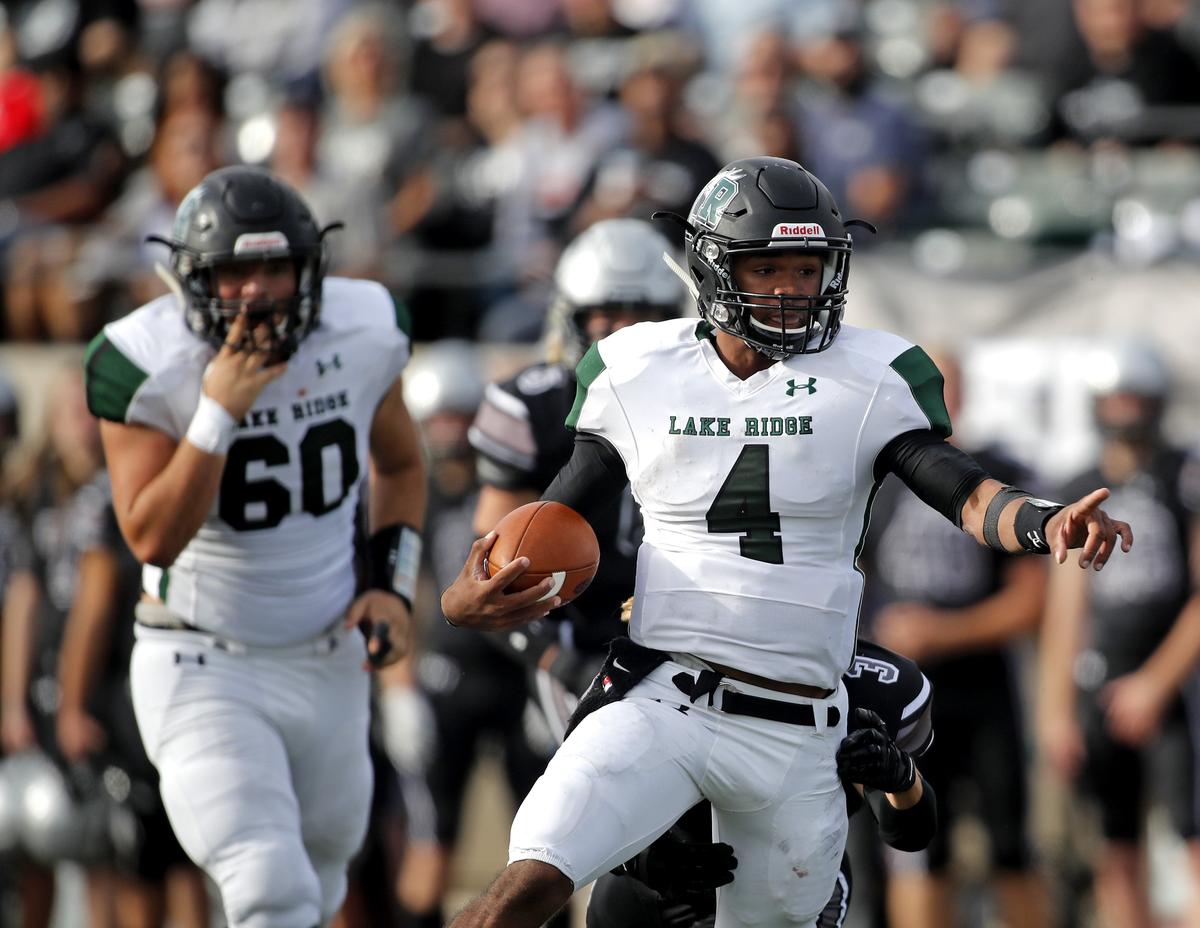 Lake Ridge quarterback Chandler Rogers (4) directs traffic as he scrambles out of the backfield in the first half of an area round high school football playoff game at Pennington Field in Bedford, Texas, Saturday, Nov. 24, 2018. Guyer led 14-7 at the half. (Star-Telegram Bob Booth)