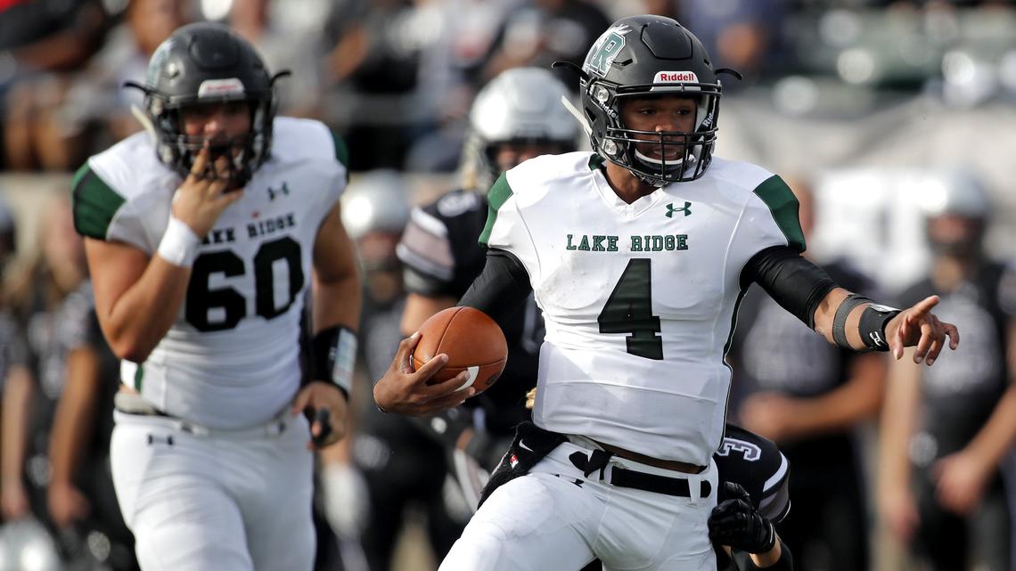 Lake Ridge quarterback Chandler Rogers (4) directs traffic as he scrambles out of the backfield in the first half of an area round high school football playoff game at Pennington Field in Bedford, Texas, Saturday, Nov. 24, 2018. Guyer led 14-7 at the half. (Star-Telegram Bob Booth)

