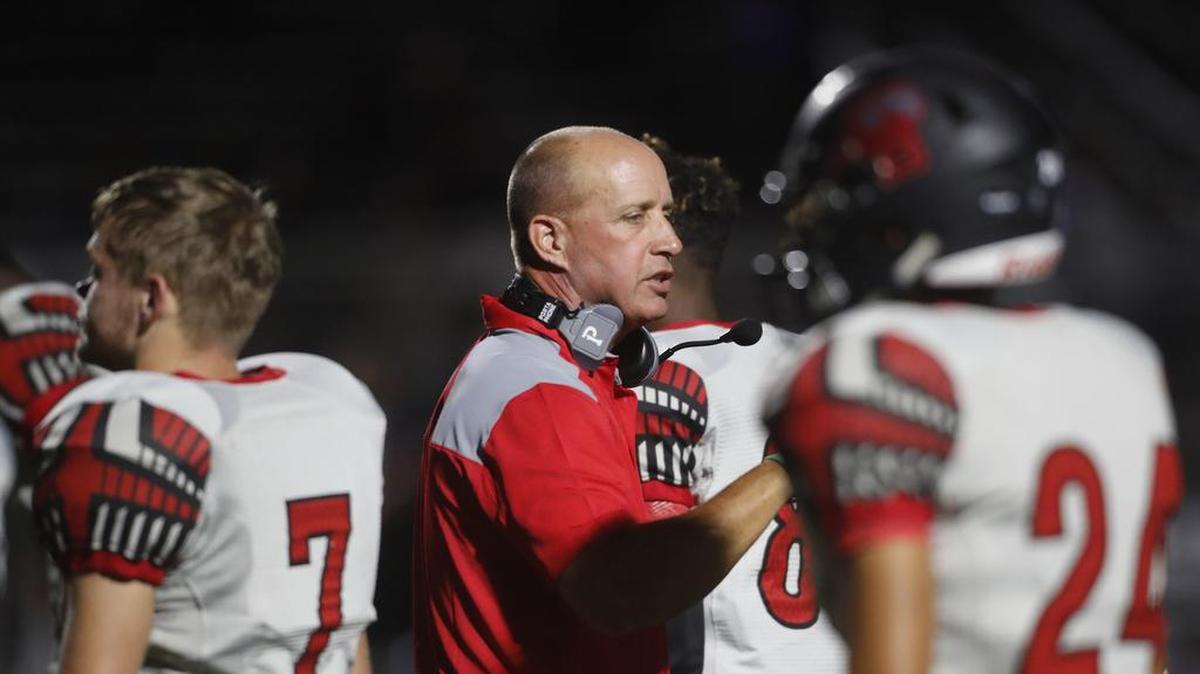 Legacy head coach Chris Melson talks to players as they head to the locker at half time as Mansfield Legacy played Crowley in September.