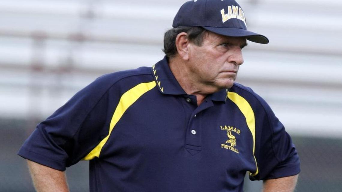 In a 2008 photo, Arlington Lamar coach Eddy Peach watches his team during pre-game warmups Keller Fossil Ridge at Cravens Field in Arlington.