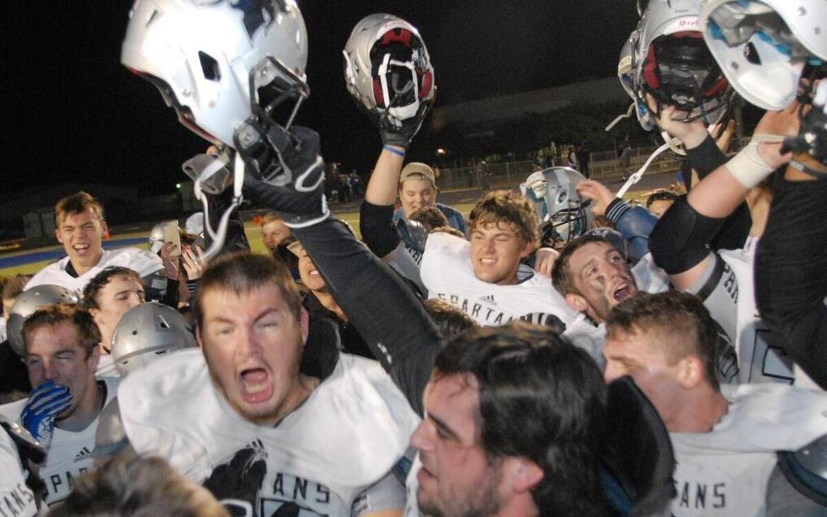 Members of the Burleson Centennial football team celebrate after their first playoff win beating Arlington Heights 30-29 in overtime, November 13, 2015, at Kangaroo Stadium in Weatherford, Texas.
