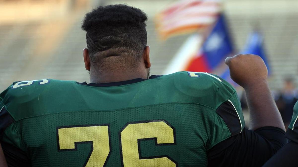 From 2016, a Western Hills player raises his fist in demonstration during the national anthem. Fort Worth Independent School District has released a policy for anthem protests in 2018.
