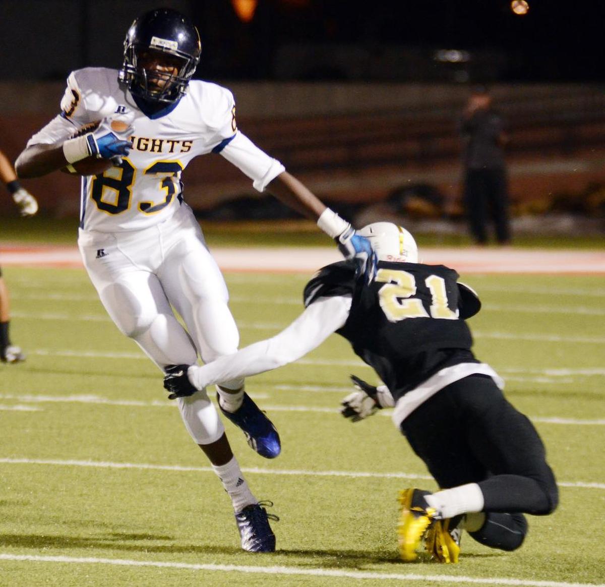 Arlington Heights wide receiver Tariq Woolen (left) escapes past Wichita Falls Rider's Draven Montgomery during a Class 5A Division I area playoff game Nov. 21, 2014, in Mineral Wells.