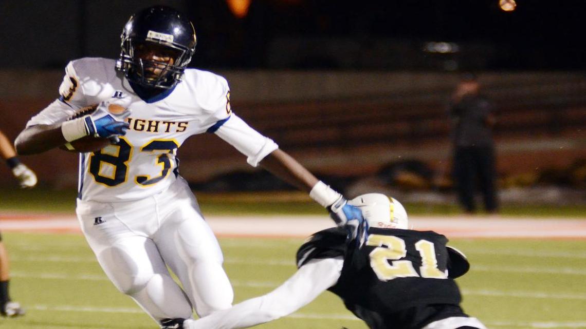 Arlington Heights WR Tariq Woolen (83) escapes past Wichita Falls Rider's Draven Montgomery during Friday's, November 21, 2014 Region I Area football game in Mineral Wells.