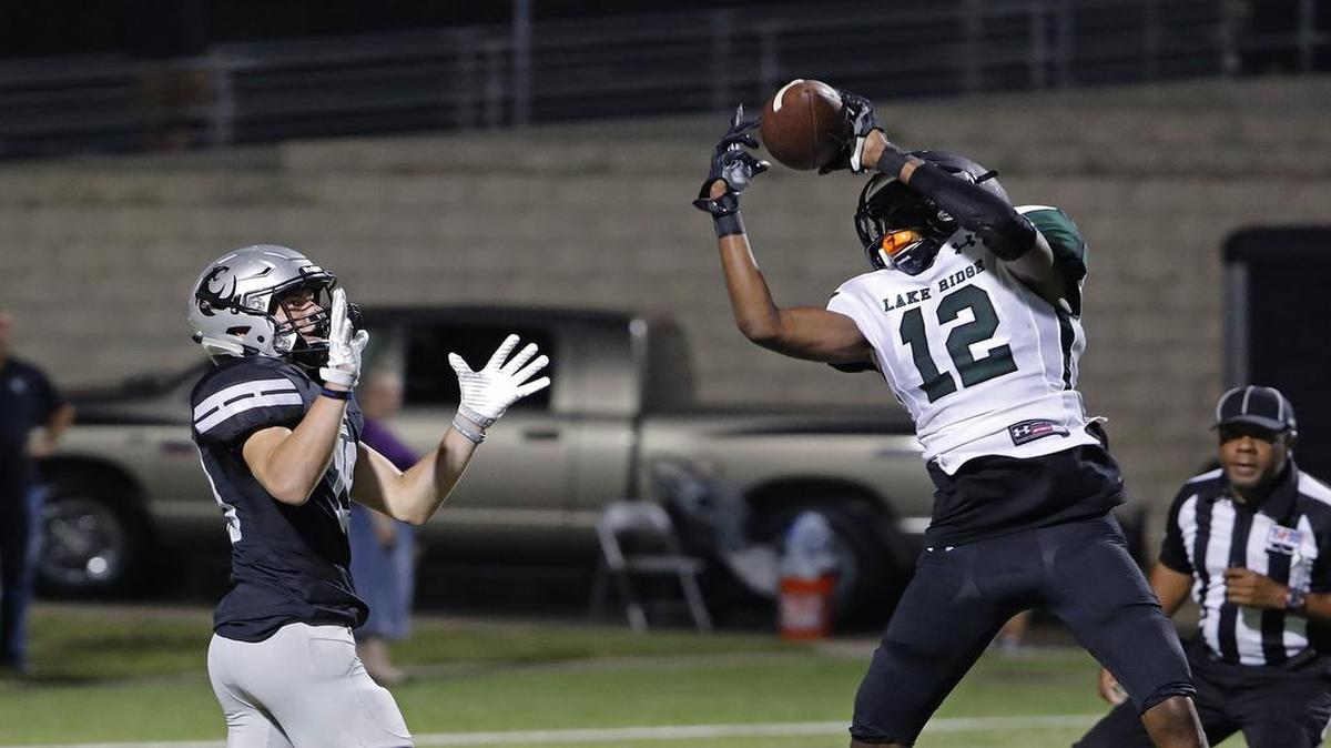 Lake Ridge safety Trejon Hugue (12) makes the pick in front of Guyer receiver Seth Meador (19) in the fourth quarter as Denton Guyer defeated Mansfield Lake Ridge 37-21 in the season opener.