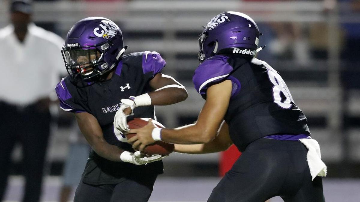 Crowley quarterback Chris James (8) pulls the ball back from running back Rodrick Williams (6) for an option as Mansfield Legacy played Crowley in high school football at Eagle Stadium in Crowley.