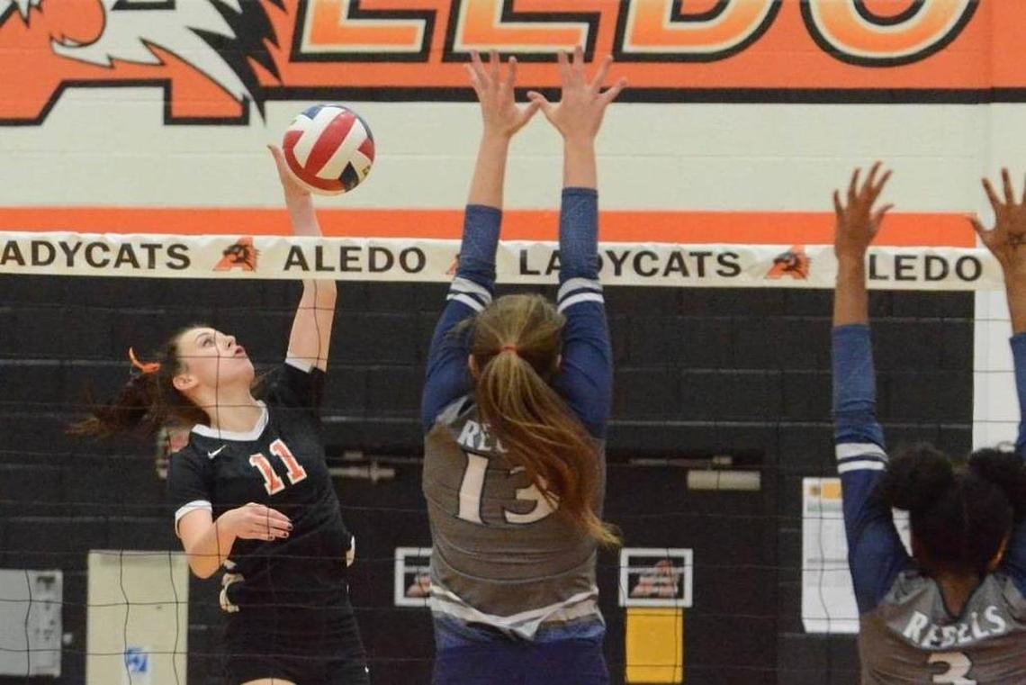 Aledo outside hitter Hannah Jones (left) goes for a kill attempt against Richland earlier this season at Aledo High School.
