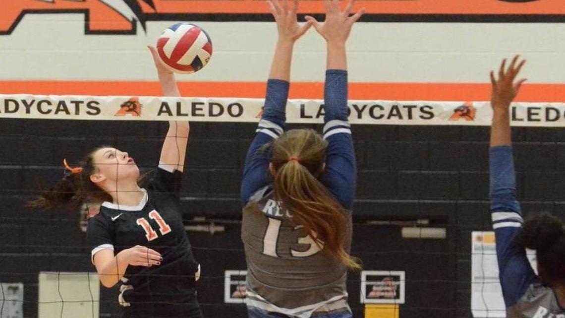 Aledo outside hitter Hannah Jones (left) goes for a kill attempt against Richland earlier this season at Aledo High School.