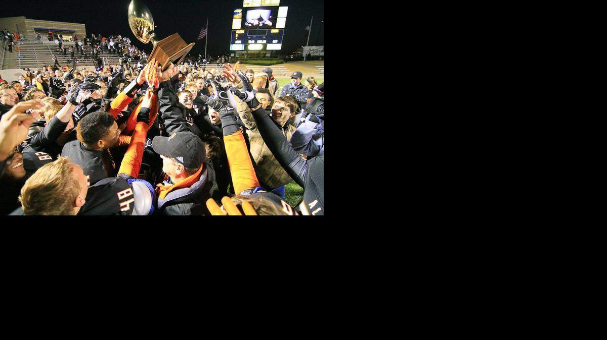 
Aledo Bearcats head coach Tim Buchanan presents the state semifinals trophy to the team after a victory over the Ennis Lions  at Midlothian ISD Stadiumon  Dec. 14, 2013. 
