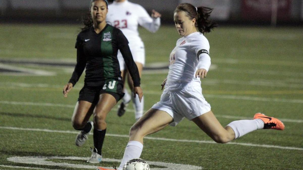 Arlington Martin’s Holly Hasten, right, sends a ball toward the goal as Kennedale’s Alondra Olmos defends in 2016. 