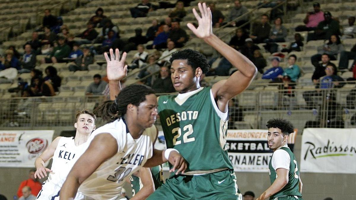 DeSoto’s 6-foot-11 post Marques Bolden, right, blocks the way of Keller center Nolan Taylor during the Whataburger Orange Basketball Tournament in December.