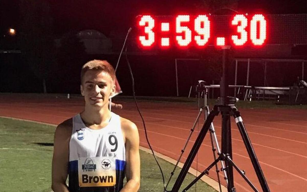 Southlake Carroll runner Reed Brown poses in front of the clock with his time at the Festival of Miles in St. Louis, June 1, 2017.