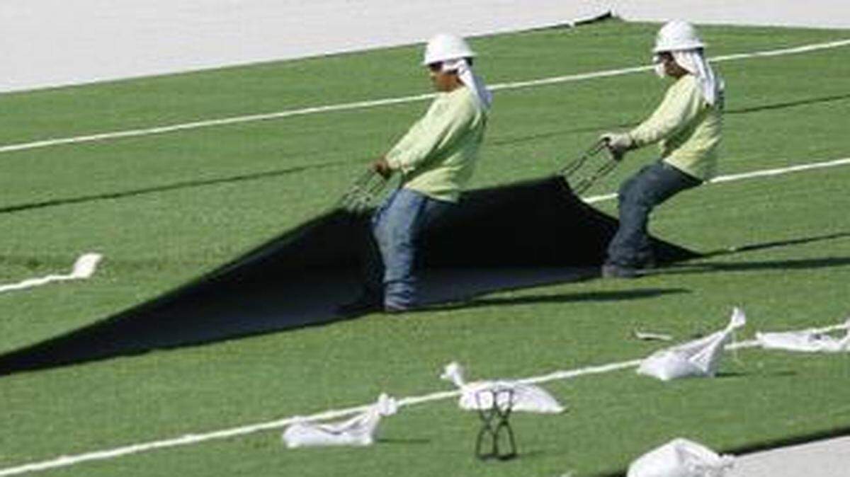 
Workers place the new turf on the football field at Arlington Heights High School on Sept. 1, 2012. Arlington Heights and Paschal are the only Fort Worth district high schools with artificial turf on practice fields. 
