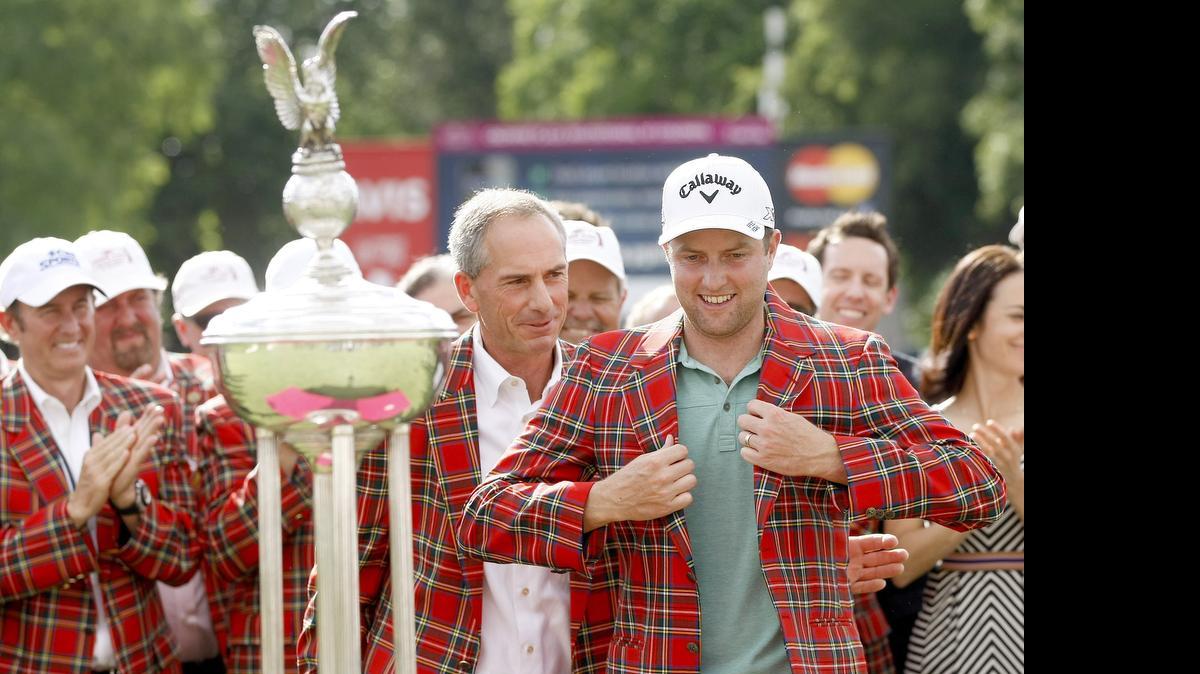 
Chris Kirk is presented with a plaid jacket after his win at the Crowne Plaza Invitational at Colonial on Sunday.
