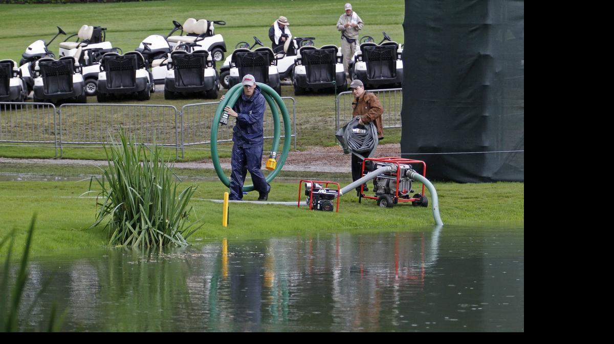 
Course workers were busy pumping water from the pond next to the ninth hole green that had overflowed during overnight rains. The water conditions delayed the start of the final round of the Crowne Plaza Invitational at Colonial on Sunday
