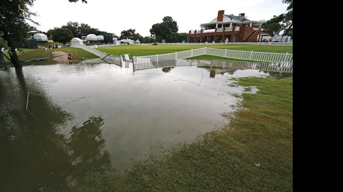 
Course workers were busy pumping and sweeping water from the course after heavy rain late Saturday and early Sunday.


