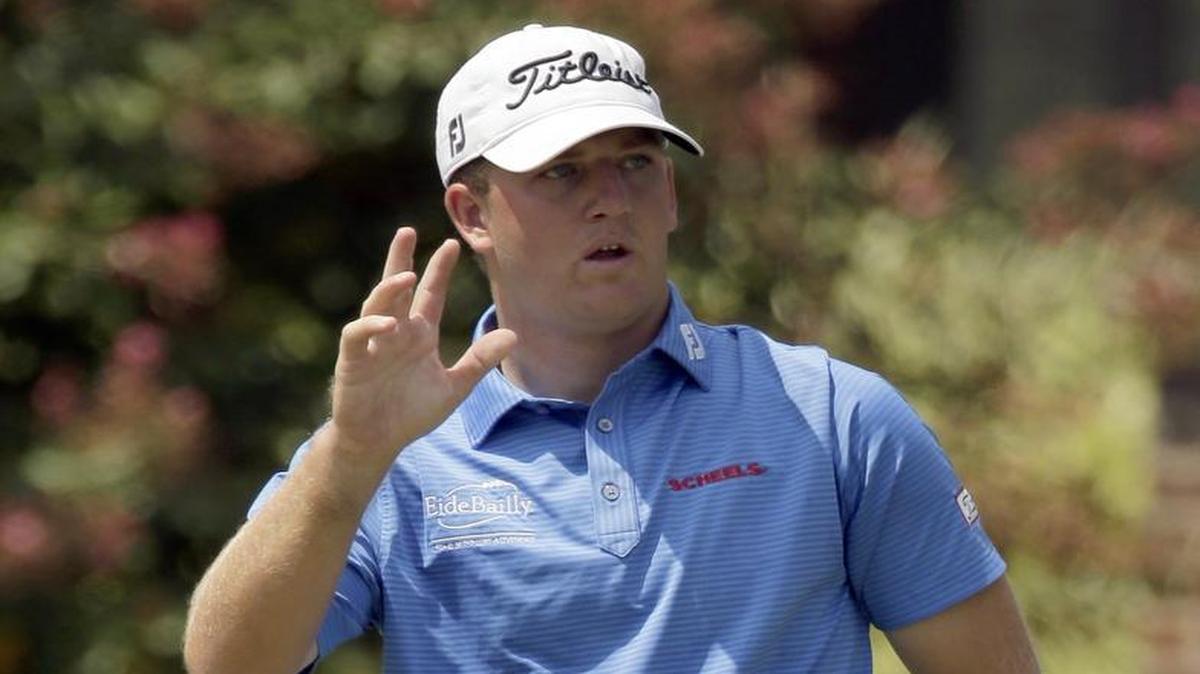 Tom Hoge waves to the crowd after making a birdie putt on the ninth hole during the second round of the Wyndham Championship golf tournament in Greensboro, N.C., Aug. 21, 2015.