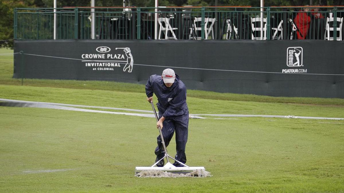 Course workers last uyear were busy sweeping water from the pond next to the ninth hole green that had overflowed during overnight rains before the final day of the PGA Tour event at Colonial Country Club. Casual water on the course requires that golfers know the rules, or make sure to ask for an interpretation.