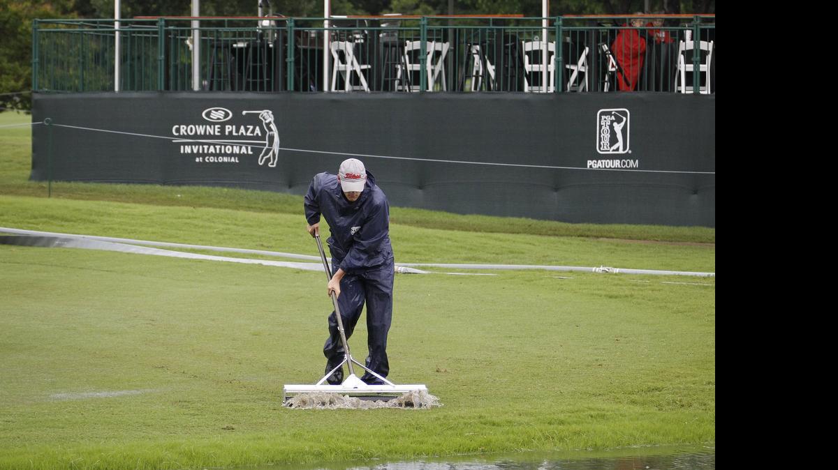 
Workers were busy sweeping water from the Colonial course Sunday morning. The start of the Crowne Plaza Invitational at Colonial was pushed back from 7 a.m. to 10 a.m.
