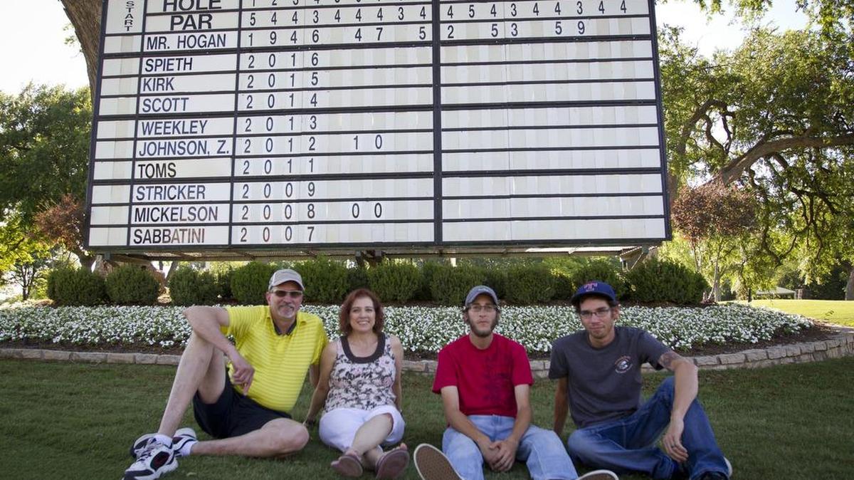 The Peets family, William, Teri, Chris and Randall, in front of the 18th hole leaderboard at the Colonial Golf course. They run the 18th leaderboard at Colonial.