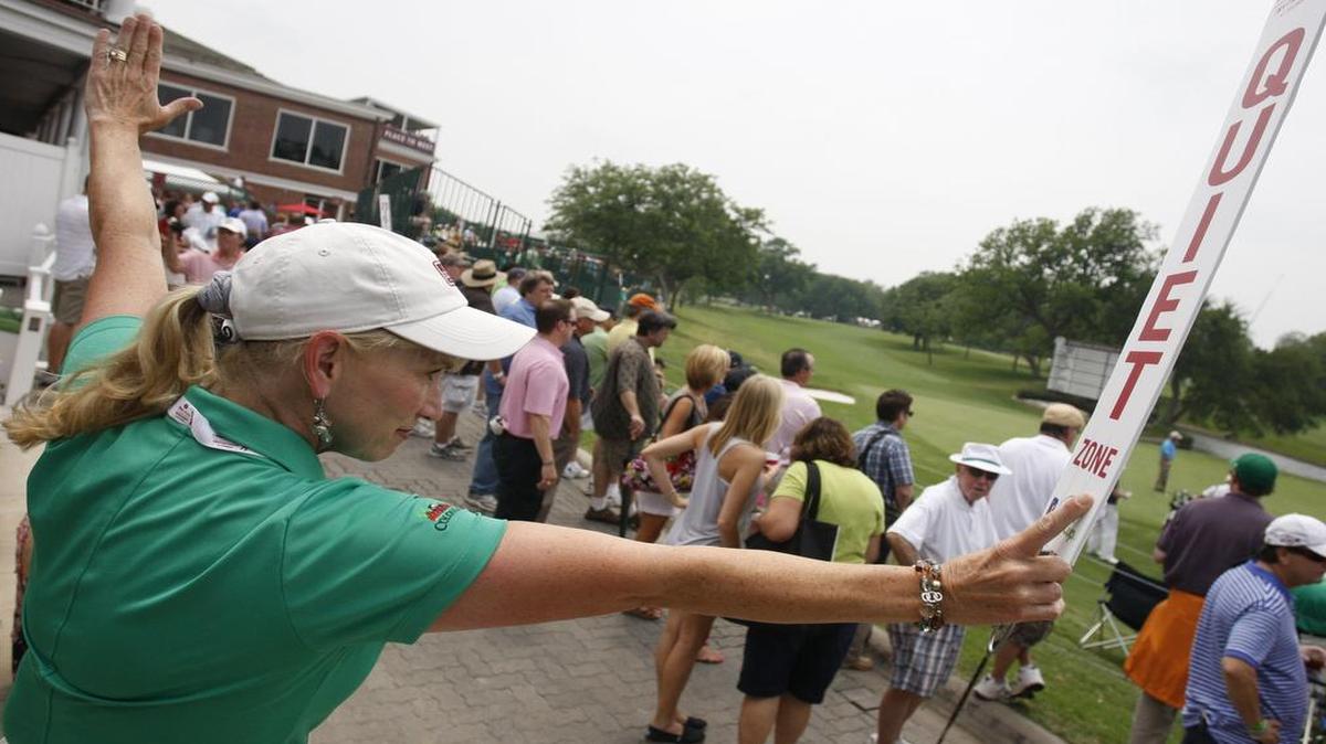 Faith Tanner, a marshal at the 18th hole, quiets a crowd at Colonial Country Club during the PGA Tour event in 2011.
