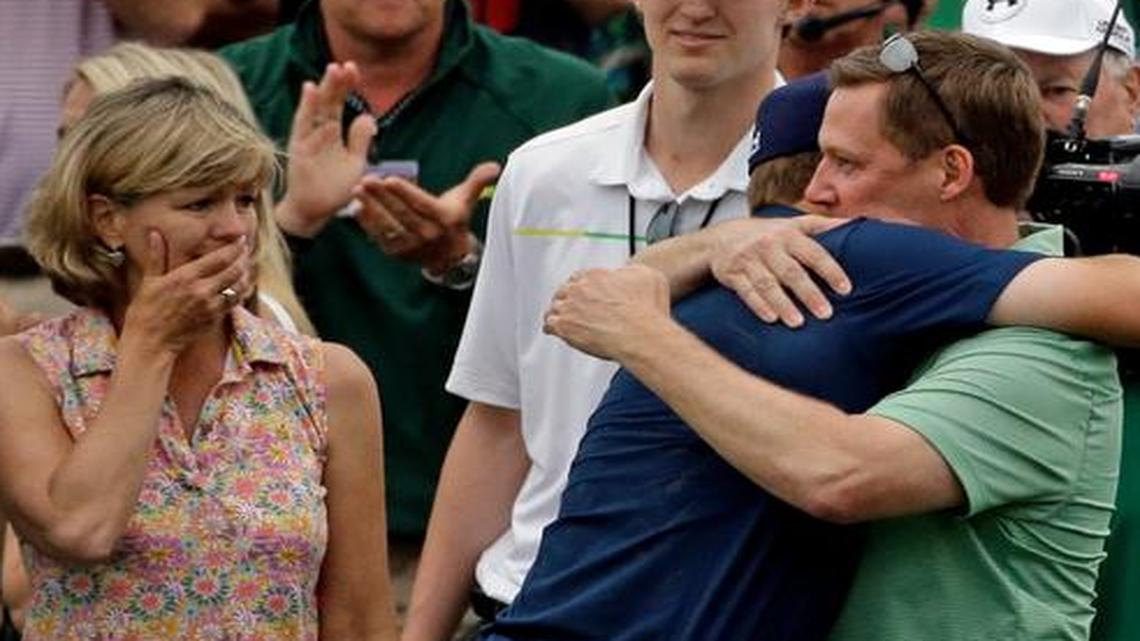 
Chris Spieth, left, watches as Jordan Spieth hugs his father, Shawn, after winning the Masters golf tournament Sunday, April 12, 2015, in Augusta, Ga. 
