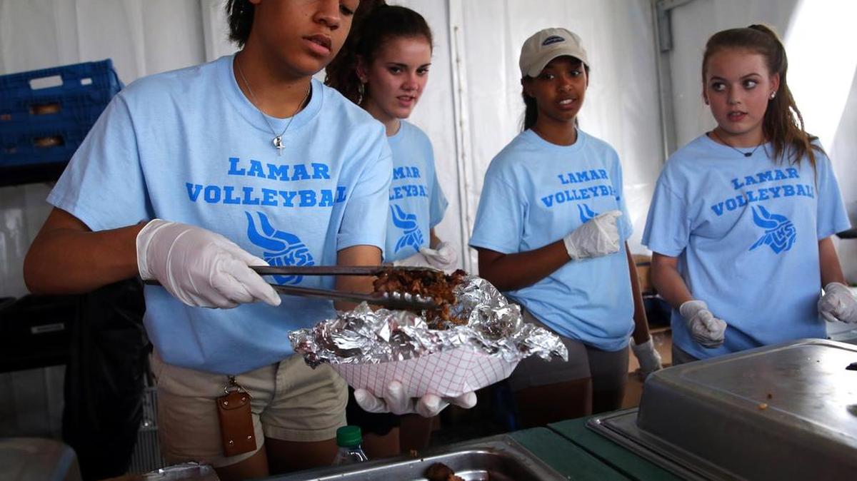 From left, Lamar HS volleyball players McKenzie Smith, Mikaela Malec, Maya Daniel and Lauren Williams work a concession stand at the 13th hole at Colonial Country Club Friday during the Dean & DeLuca Invitational.