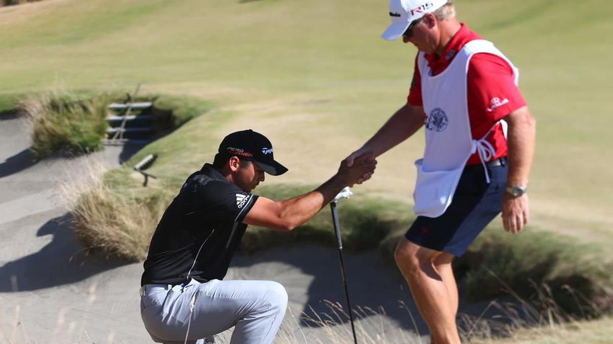 
Caddie Colin Swatton helps Jason Day out of a bunker on the 10th hole during the final round of the U.S. Open golf tournament on Sunday, June 21, 2015, at Chambers Bay in University Place, Wash. 
