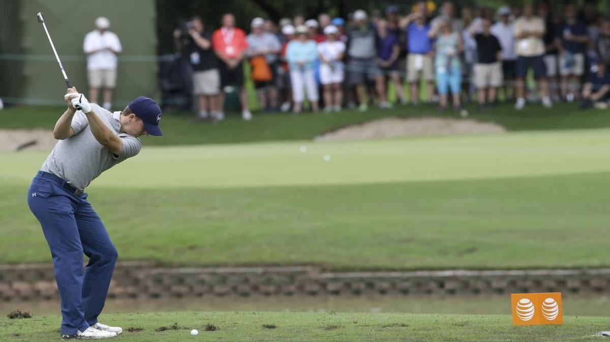
Jordan Spieth hits a tee shot on the shortened 14th hole during the second round of the Byron Nelson golf tournament on Friday. The 14th fairway was washed over by a flash flood so the the hole was shortened to a 100-yard par 3.

